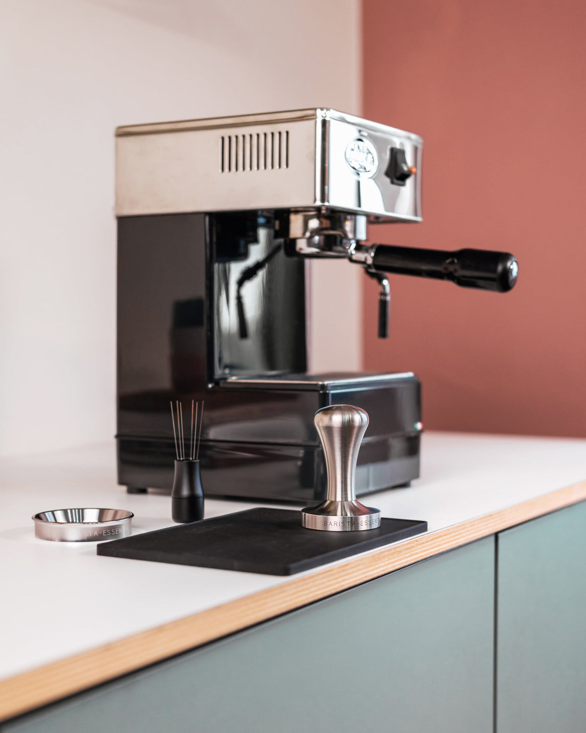 RVS tamper op een werkblad bij een espressomachine
